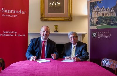 Robin Foale and Rector Trainor sign the agreement.