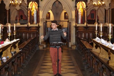 Organ scholar conducts Exeter College choir during a rehearsal