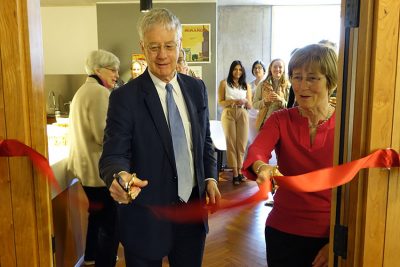 Hamish McRae and Dame Frances Cairncross cut a ribbon at the formal opening of the kitchens at Cohen Quad