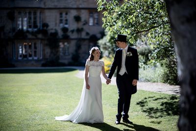 Wedding couple walking through the Fellow's Garden