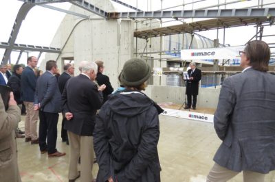 Rector Trainor addresses guests at the topping out ceremony at Cohen Quad
