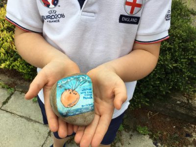 Ella Dickson decorates rocks with illustrations of book covers