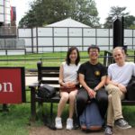 Exeter College Summer Programme Students sitting on a bench, smiling.