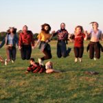 Exeter College Summer Programme Students jumping in a meadow