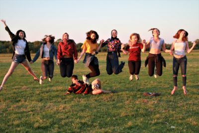 Exeter College Summer Programme Students jumping in a meadow