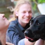 Exeter College Summer Programme Students with a Black Labrador