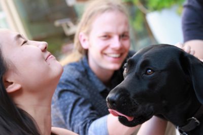 Exeter College Summer Programme Students with a Black Labrador