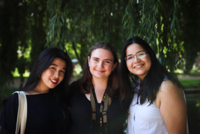 three students smiling