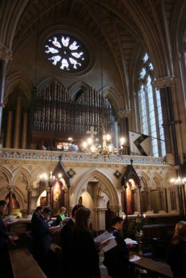 Inside Exeter College Chapel showing Choir singing