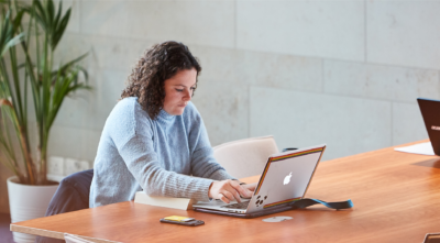 student in Cohen Quad using laptop