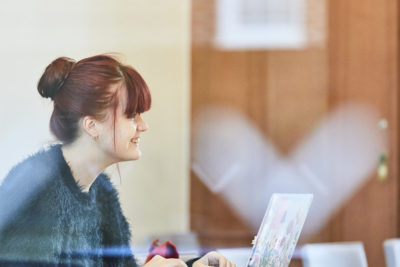 student in Cohen Quad using laptop