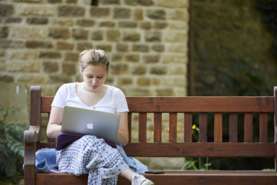 student studying on a laptop outdoors