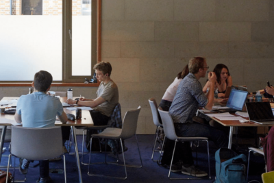 Students and staff meeting and working in Cohen Quad