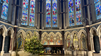 Stained Glass in the Chapel lit up with Christmas tree in the evening