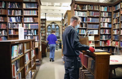 Library with book shelf and two students