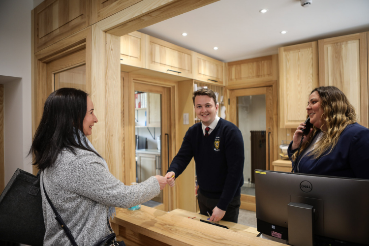 Lodge Supervisor, Hughie Hicks and Head Lodge Porter, Sarah McCowie working in the lodge handing out keys and taking calls 