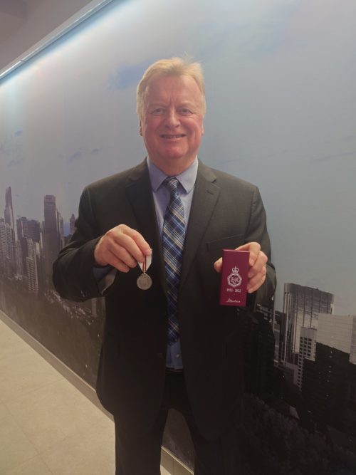 Paul Paynter holding the Queen Elizabeth II Platinum Jubilee Medal