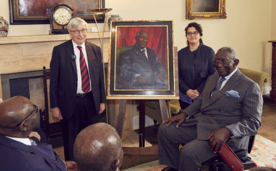 Rector Rick Trainor, John Kufuor, and artist Naima Aouni with John Kufuor's portrait