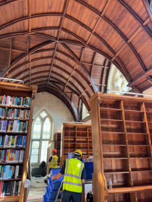 Library construction with workers putting books into shelves
