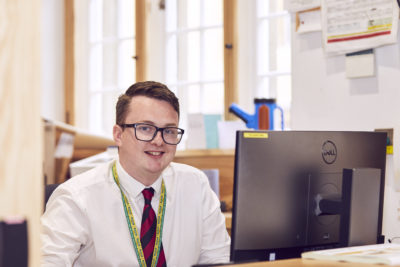 Porter sitting in the Exeter College Porters' Lodge