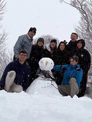 Exeter students with a snowman