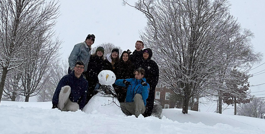 Exeter students with a snowman
