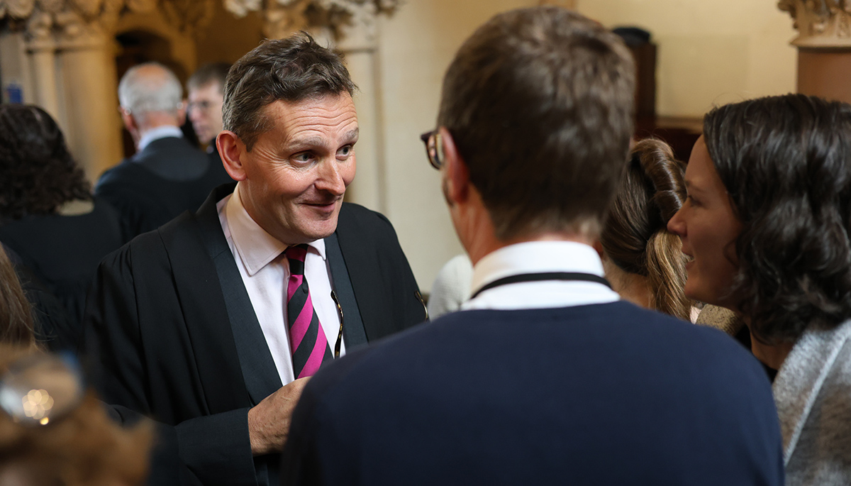 Rector Roe talks with staff in the Chapel