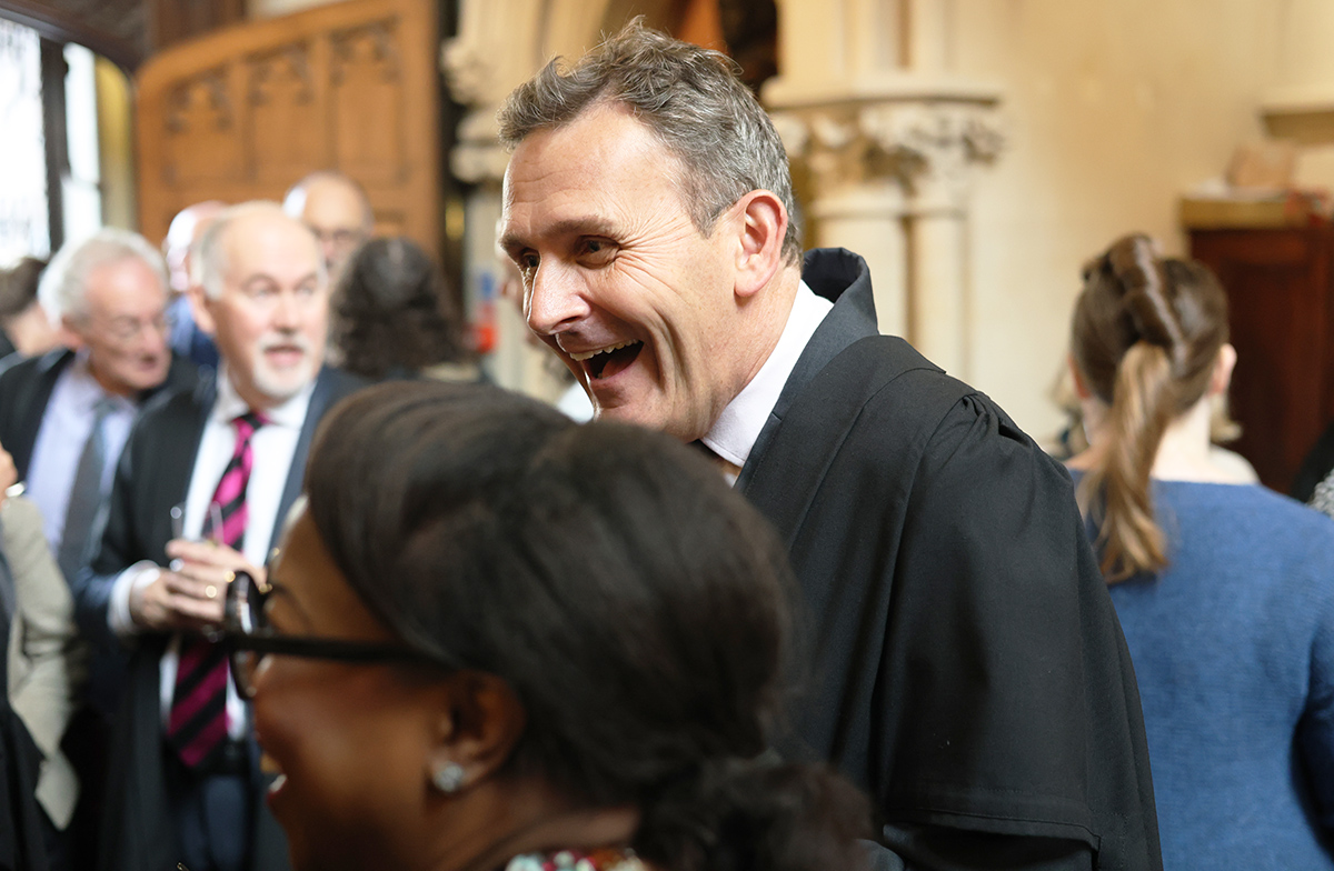 Rector Roe talks with Fellows in the Chapel
