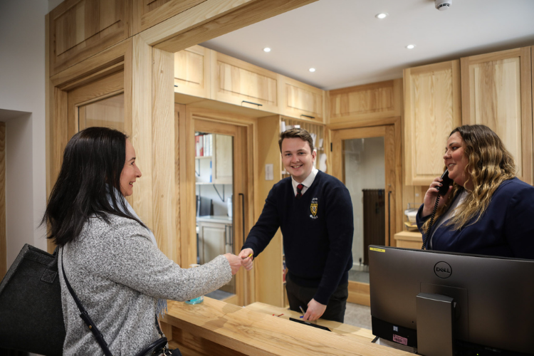 Lodge Supervisor, Hughie Hicks and Head Lodge Porter, Sarah McCowie working in the lodge handing out keys and taking calls