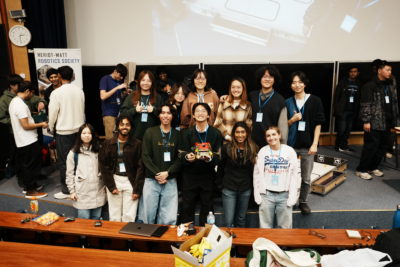 Exeter College students, Azka Adziman (2023, MEng Engineering Science) and Sky Alexander (2025, MEng Engineering Science) with the team of OxBots